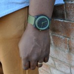 A green Nixon watch pulls the colour blocked look together